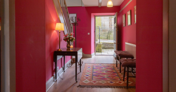 view of colourful pink hall way inside a holiday cottage at The Auckland Project, Bishop Auckland.